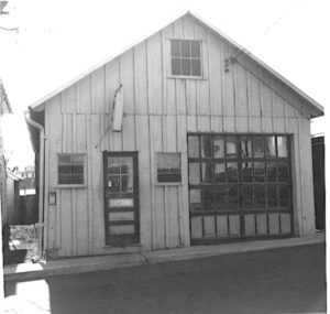 PHOTO TAKEN IN 1965 SHOWS THE BUILDING THAT WAS THE COURTLAND STREET FIRE STATION. THE DOUBLE SWINGING DOORS HAVE BEEN REPLACED WITH A ROLL-UP DOOR.